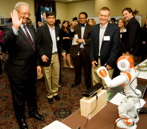 Congressman waves at robot, who waves back