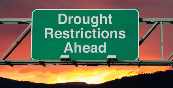 highway sign reading 'drought restrictions ahead'
