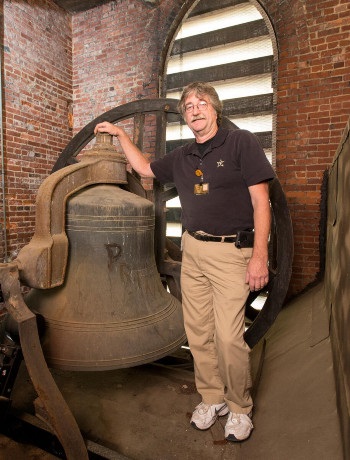 The late Paul Young standing by Kirkland Hall bell that was installed in 1906