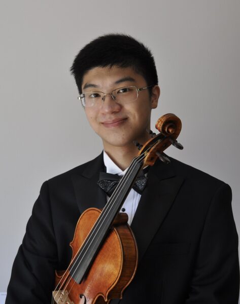 Headshot of Kingston Ho, third year student, and his violin