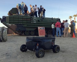 model amphibious tank next to real one