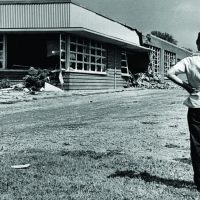 A perplexed little boy surveyed the damage done to Hattie Cotton School by dynamite. September 10, 1957. Photo by Bill Preston. Courtesy of The Tennessean
