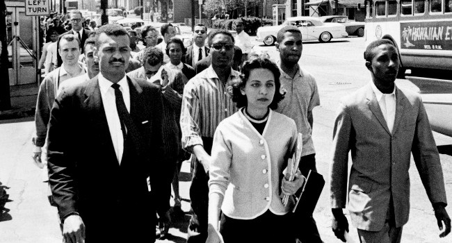 On April 19, 1960, the day of the Z. Alexander Looby bombing, as many as 4,000 demonstrators marched down Jefferson Street toward city hall. In the first row are Rev. C.T. Vivian (left), Diane Nash of Fisk University, and Bernard Lafayette of American Baptist Seminary. In the second row are Kenneth Frazier and Curtis Murphy of Tennessee A&I, and Rodney Powell of Meharry. Using his handkerchief in the third row is Rev. James Lawson. (Jack Corn/courtesy of The Tennessean)