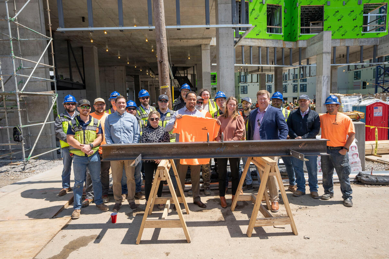Graduate and professional student housing project celebrates milestones with topping out ceremony, announces first retail business