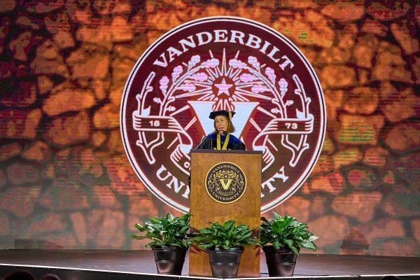 C. Cybele Raver speaks at a podium on stage