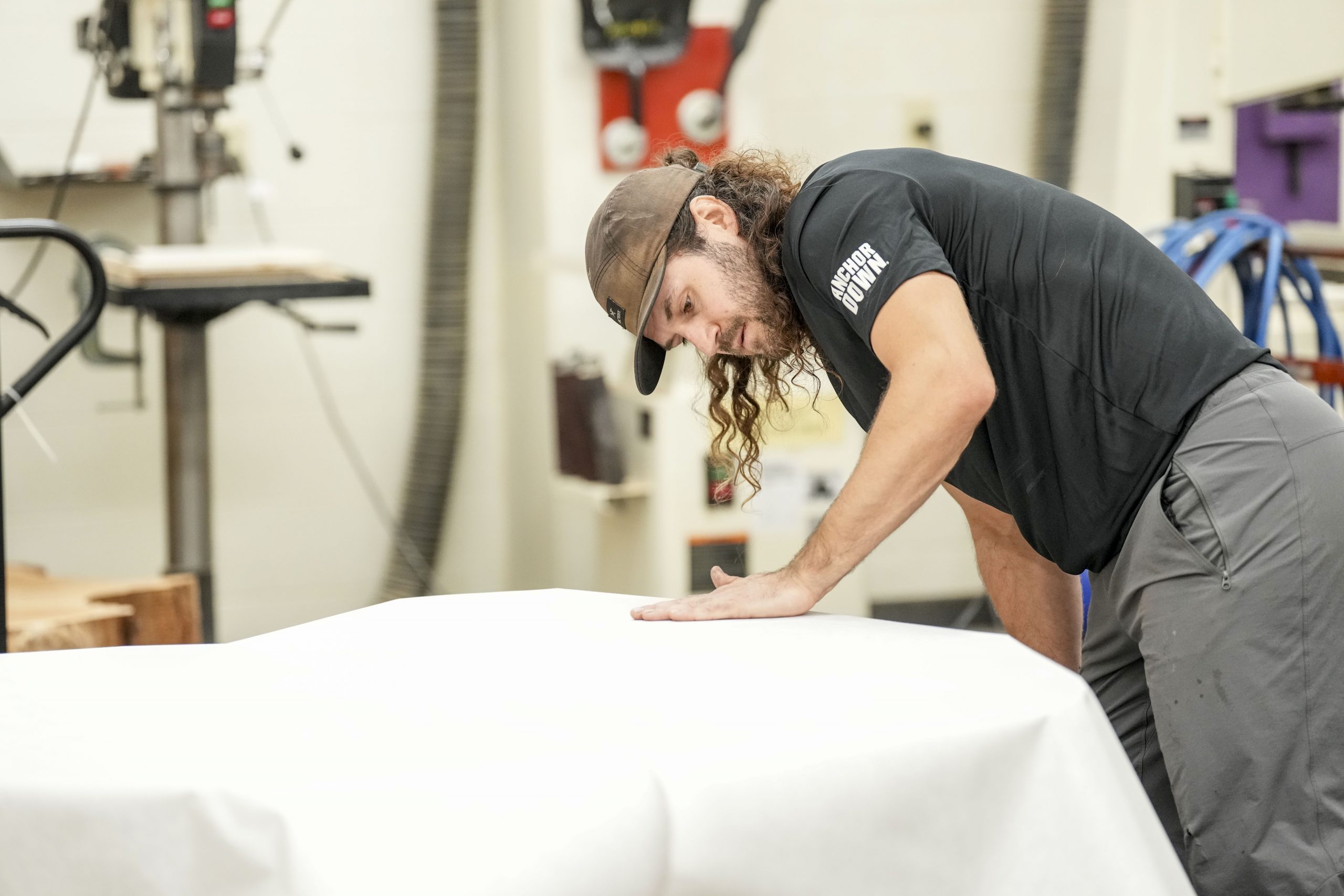 Art students watch as Artist Marko Barakoski makes tree prints at  Ingram Fine Arts studio using the wood from the Bicentennial Oak that fell on campus in 2022.