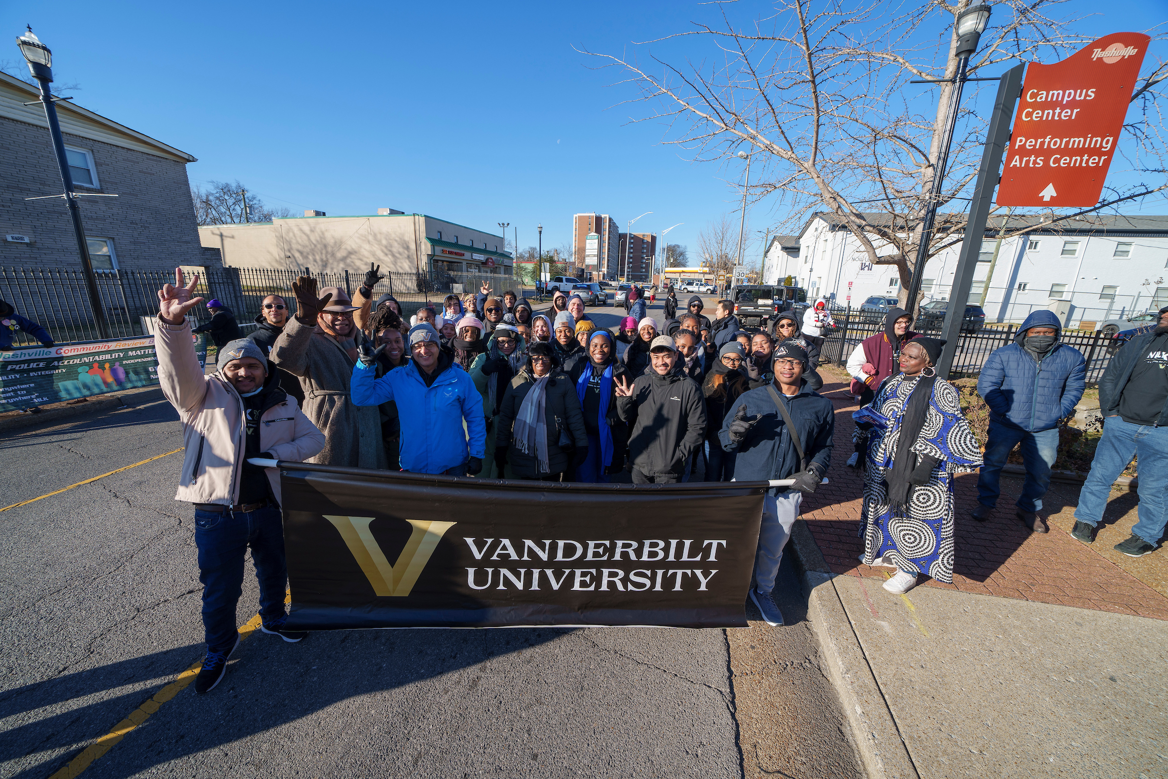 Group of Vanderbilt students holding a university banner.