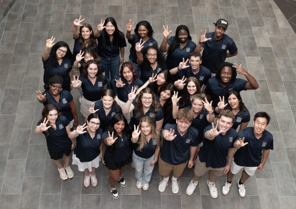 Group of PTY staff make Vanderbilt hand signs