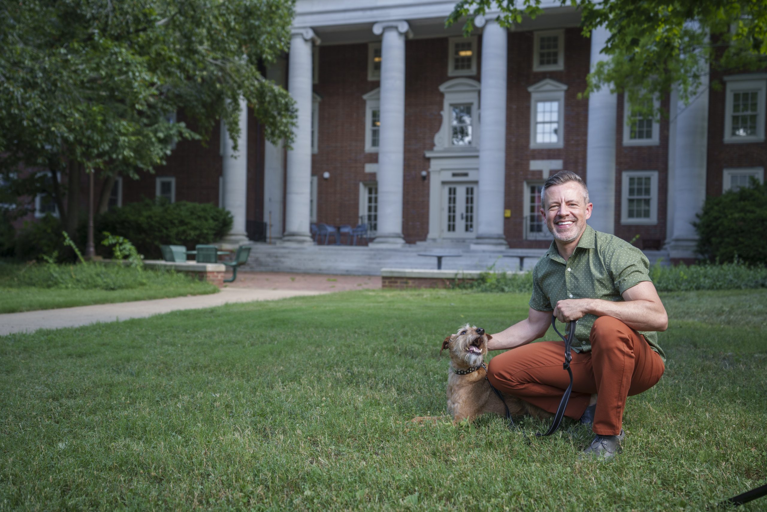 Justin Quarry outside of East House with his dog, Malcolm.
