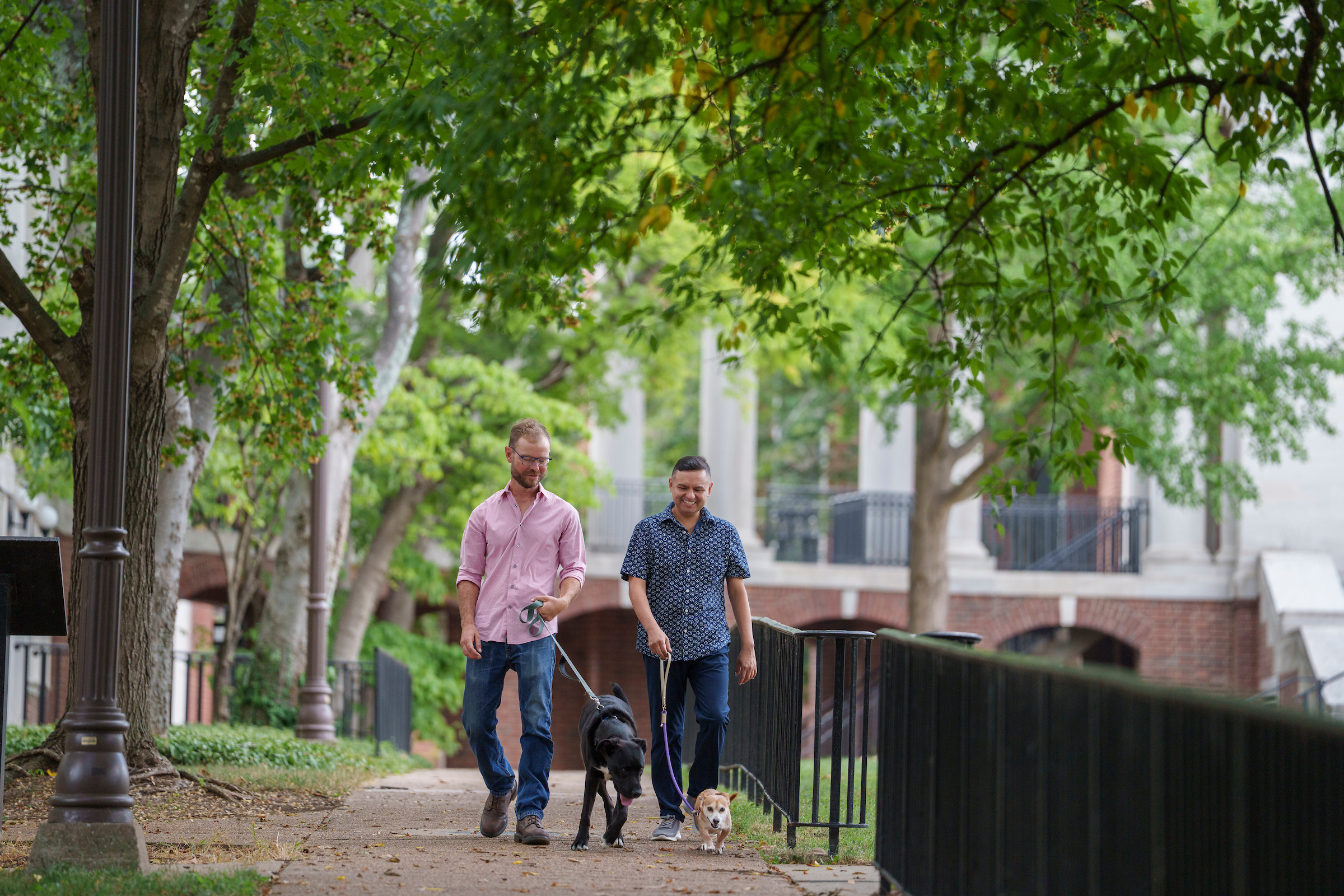 Gilbert Gonzales, associate professor of medicine, health and society, director of public policy studies and associate director of the LGBTQ+ Policy Lab with his spouse, Andy, and their dogs, Jack and Freddie (Harrison McClary/Vanderbilt University)