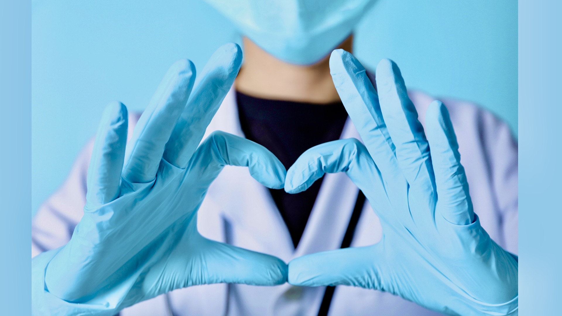 medical professional making a heart sign