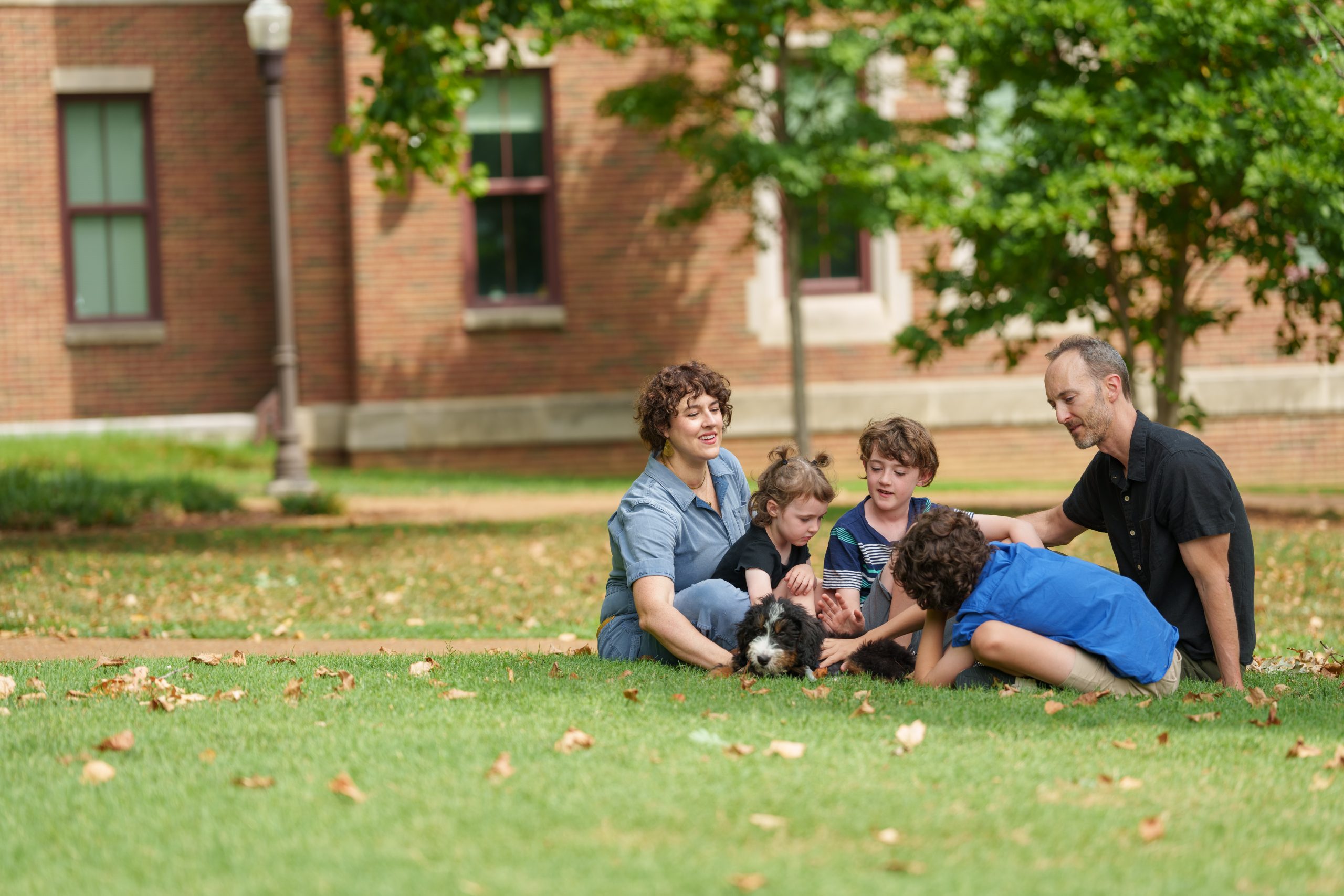 Robin Michael Jones, associate professor of hearing and speech sciences, with his wife, Kristin, their children Arlo, Bodhi and Leona, and their puppy, Pawley 