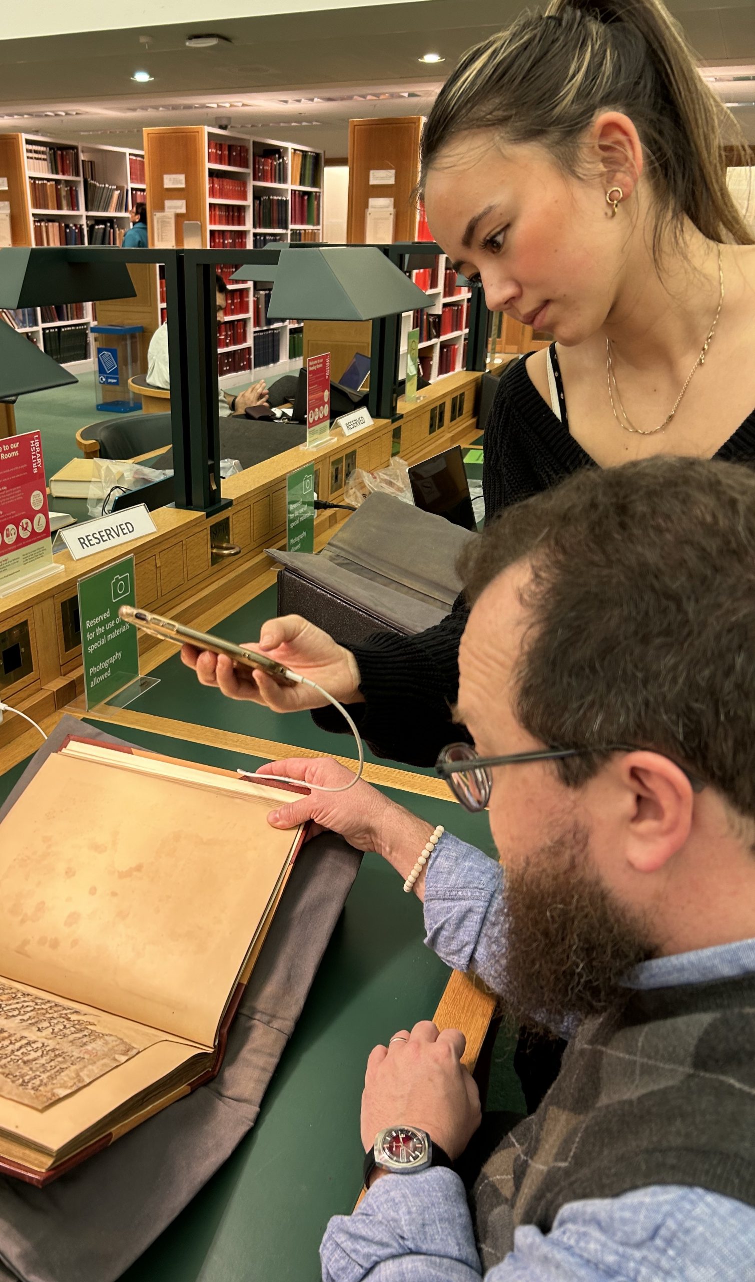 Alexys Ahn (BA’24) and Professor David Michelson consult a Syriac manuscript in the British Library. Photo Credit: Kurt Urban, BA’24. 