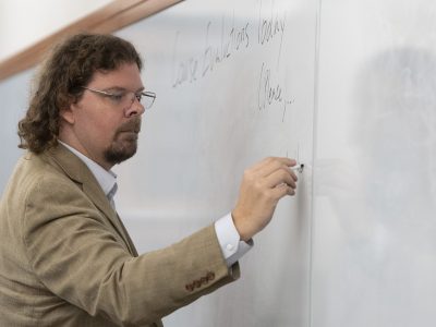 Bennett Landman writes on a whiteboard