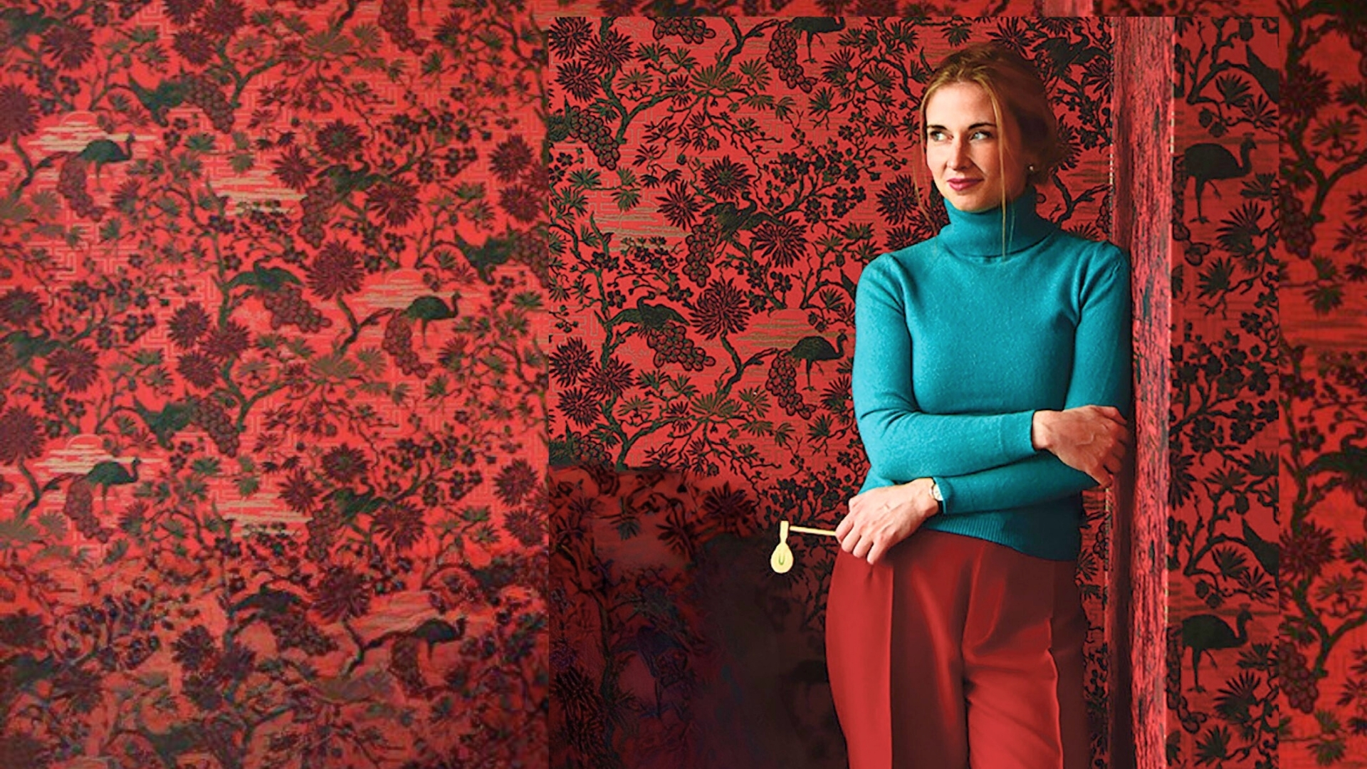 Nora Pertz in teal and red against a floral red wallpaper