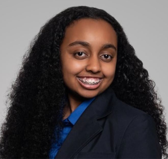 teenage girl in black suit and blue blouse