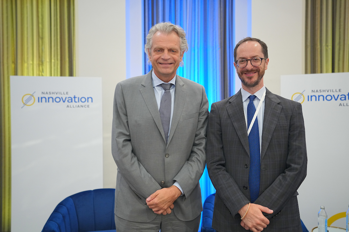 Chancellor Diermeier and Mayor O'Connell stanf side by side against a blue and yellow backdrop with signage for the Nashville Innovation Alliance