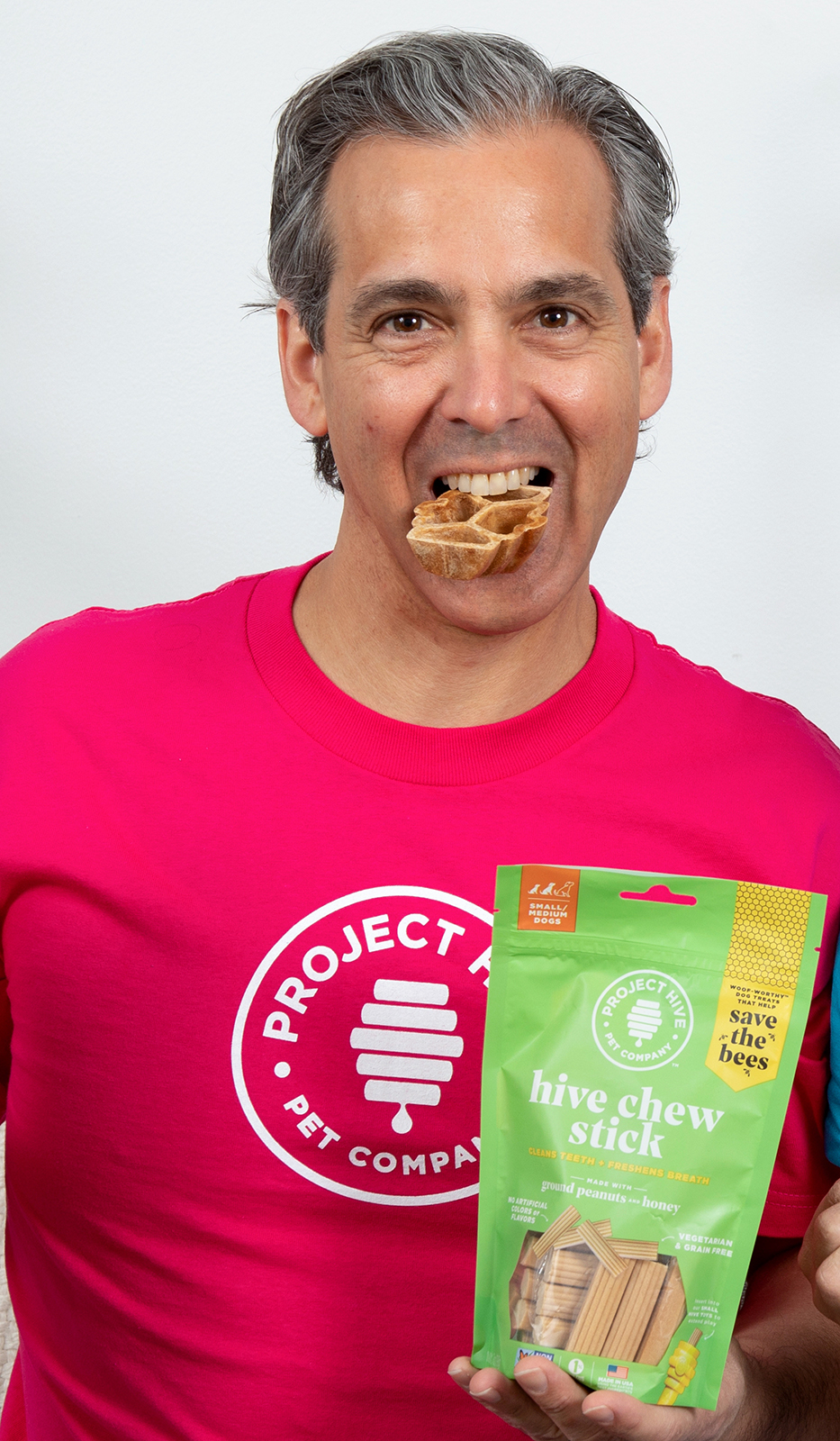 Jim Schifman, with a honeycombed-shaped dog treat in his mouth