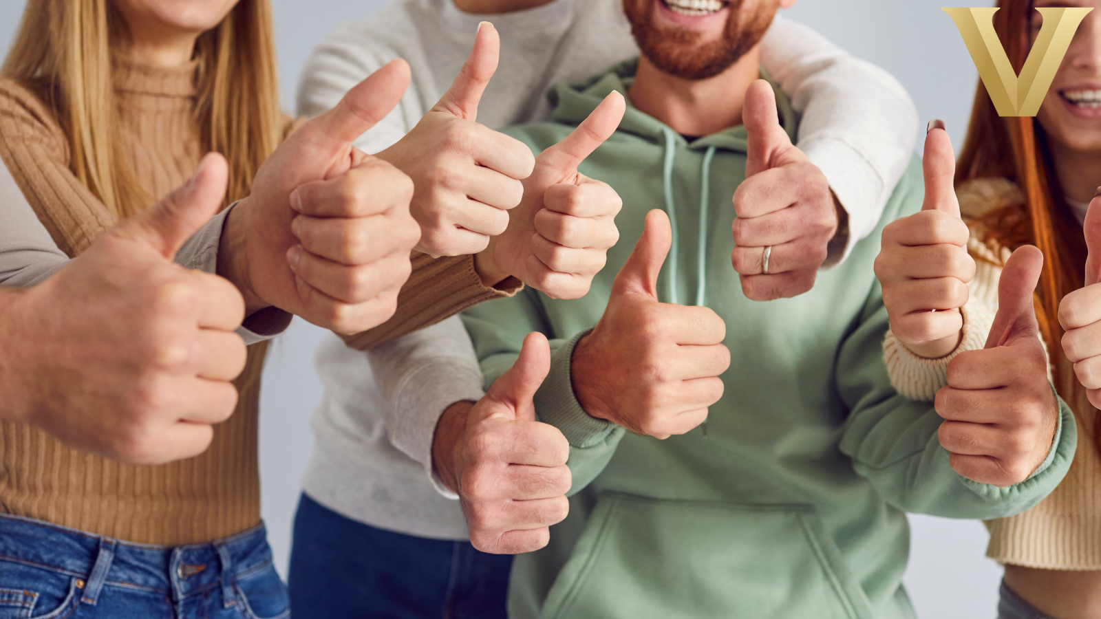 A group of people give thumbs up