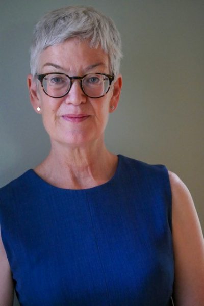 headshot photo of Leah Lowe in blue dress