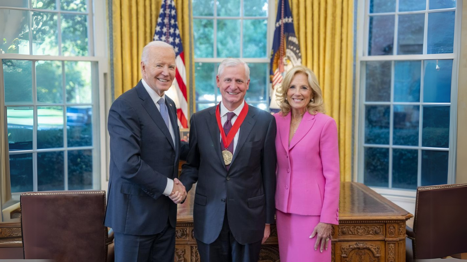 President Joe Biden shakes hands with Jon Meacham alongside First Lady Dr. Jill Biden in the Oval Office during the presentation of the National Humanities Medal to Meacham. Photo provided by the White House.