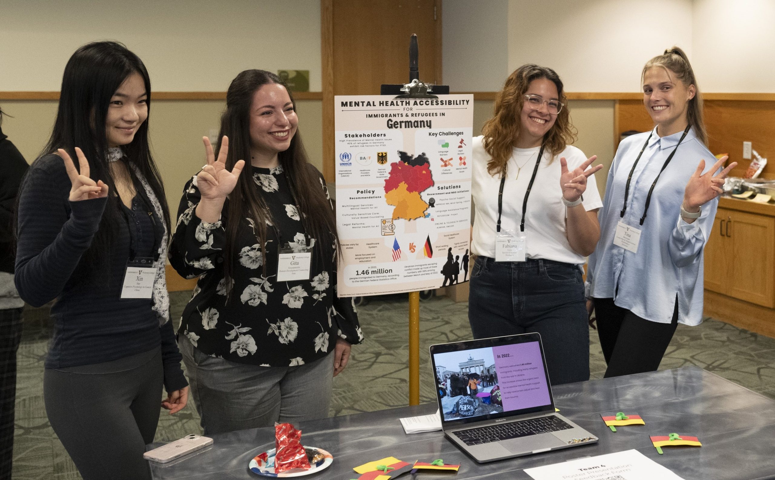 Four female students presenting research poster