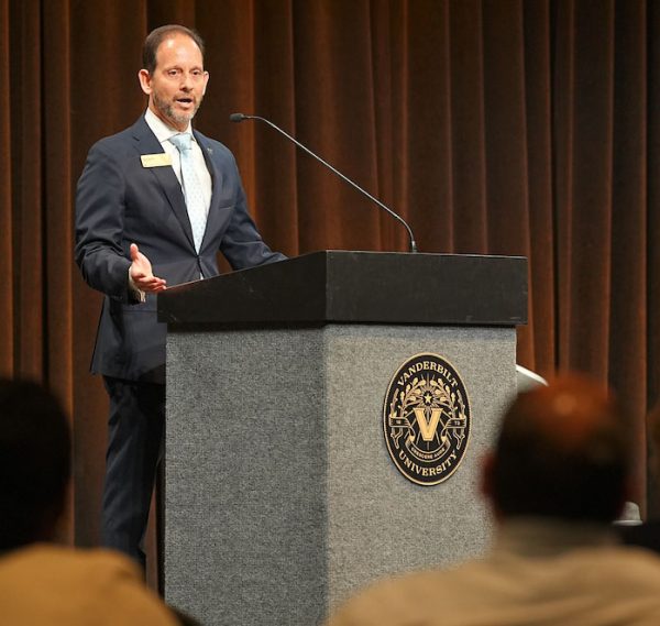 Vice Provost Alex Sevilla speaks to a crowd from a podium