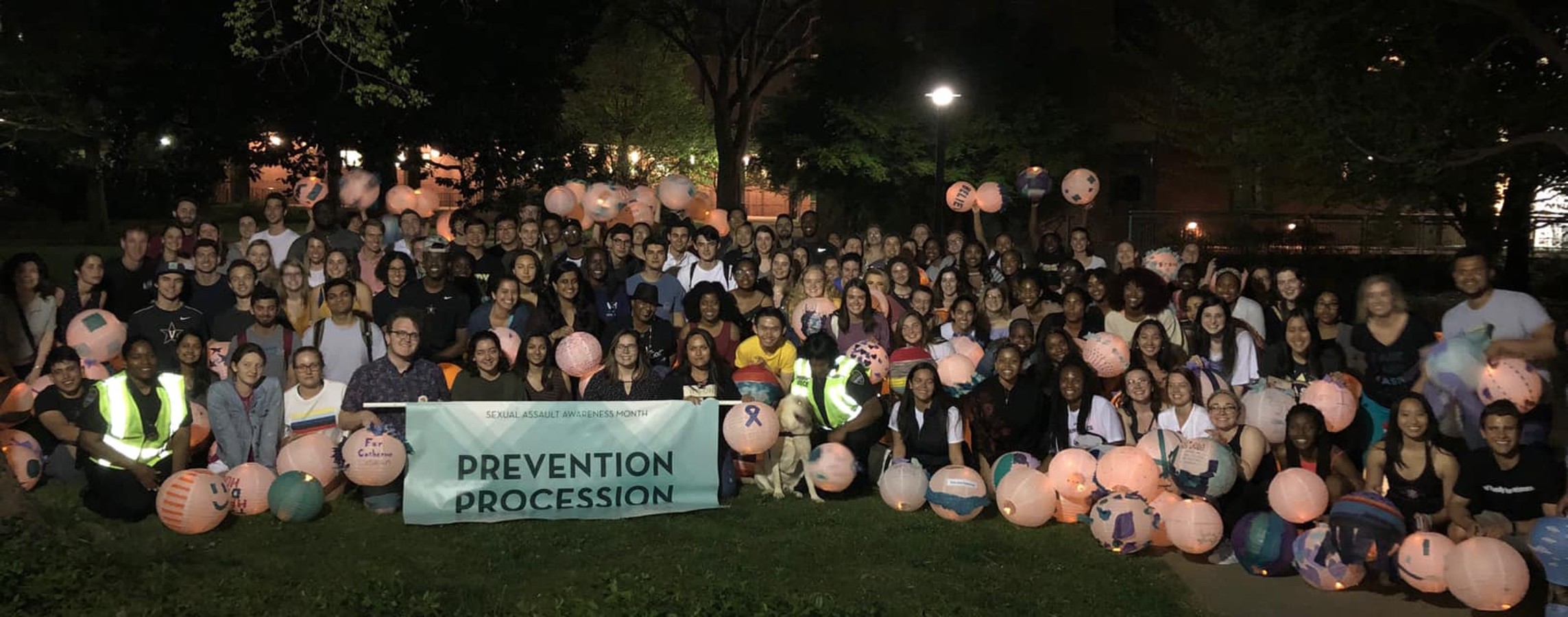 Large group of students participating in Prevention Procession during Sexual Assault Awareness Month