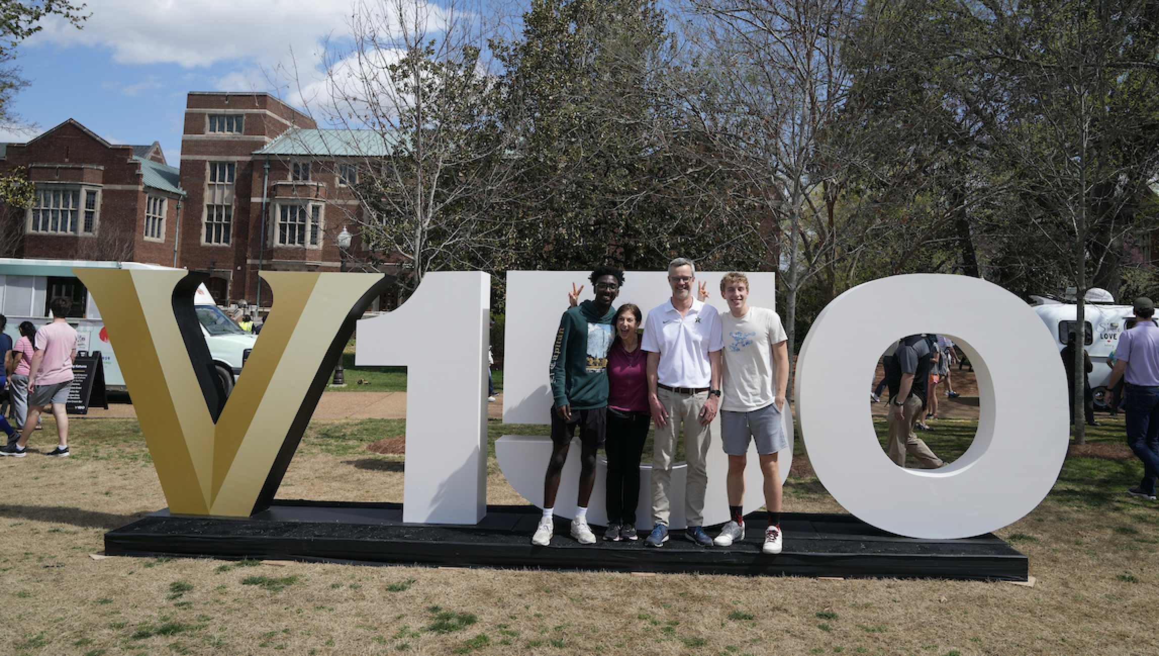 Vanderbilt community members pose with the V150 sign at the Sesquicentennial kickoff celebration on Alumni Lawn. (Joe Howell)