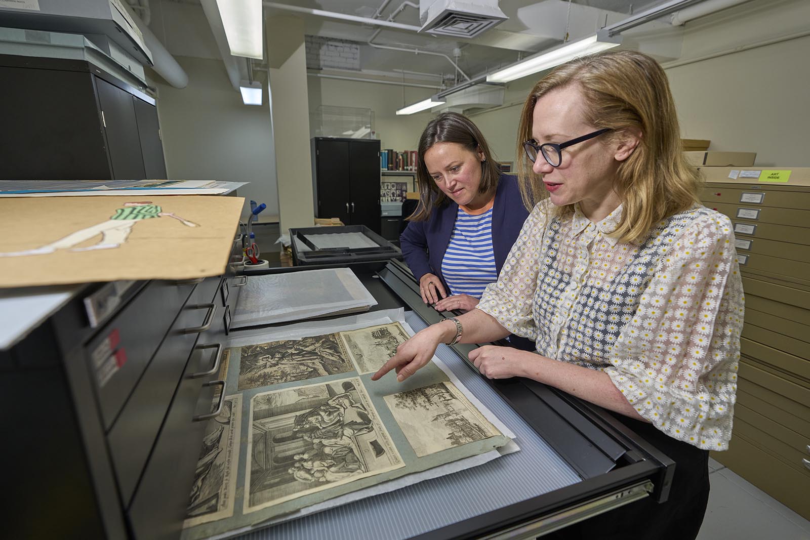 In the basement storage of the Vanderbilt University Museum of Art in Cohen Memorial Hall, Amanda Hellman and Courtney Wilder look at new Sullivan Collection prints.