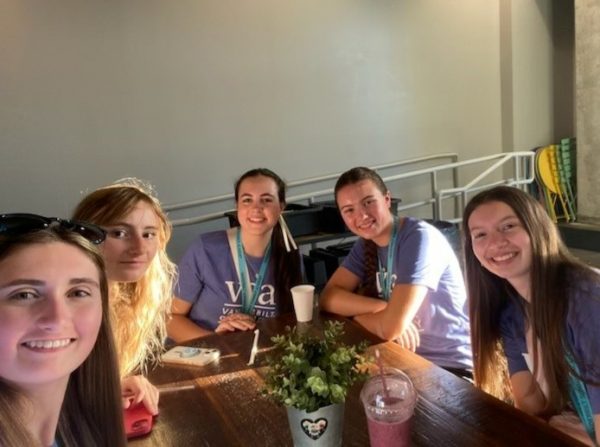 Five PTY teenage students sit around a table