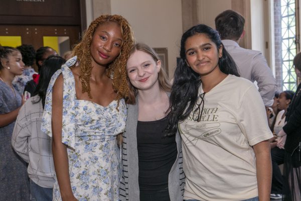 Several students smile at the exhibit opening