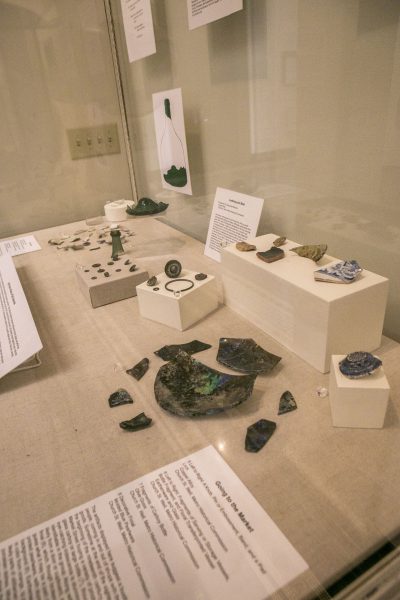 Plate and pottery fragments inside a display case