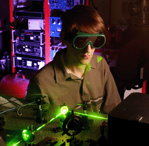 Student John Jumper uses a laser while wearing goggles.