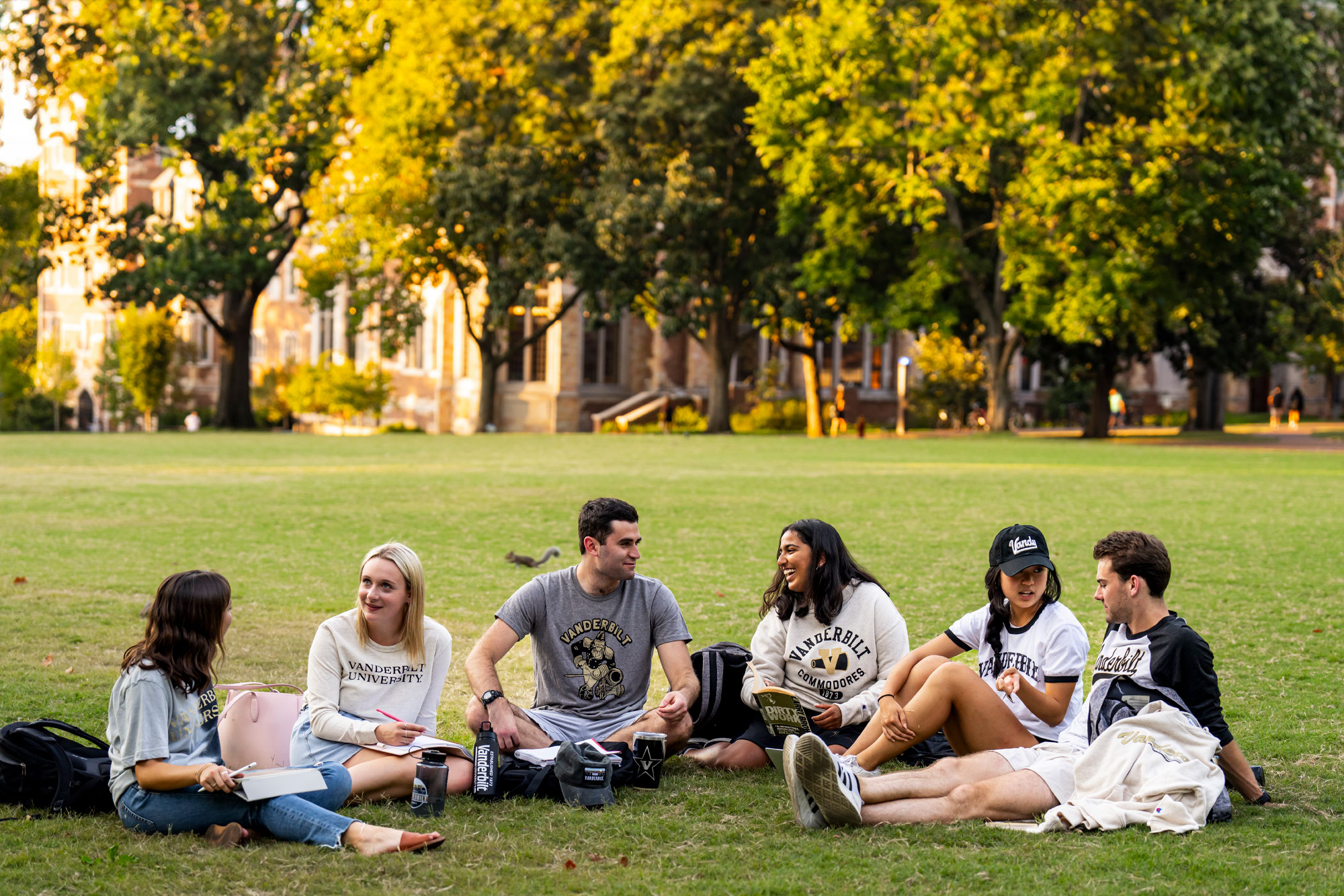 Students in Vanderbilt gear talk on the lawn