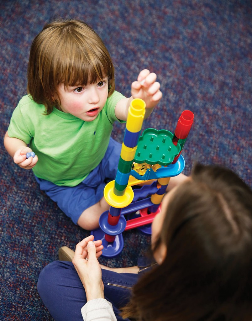 Speech–language pathologist Carolyn Estopinal works with 2-year-old Bentley Baker