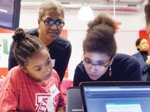 Photo of African American girls at desktop computer