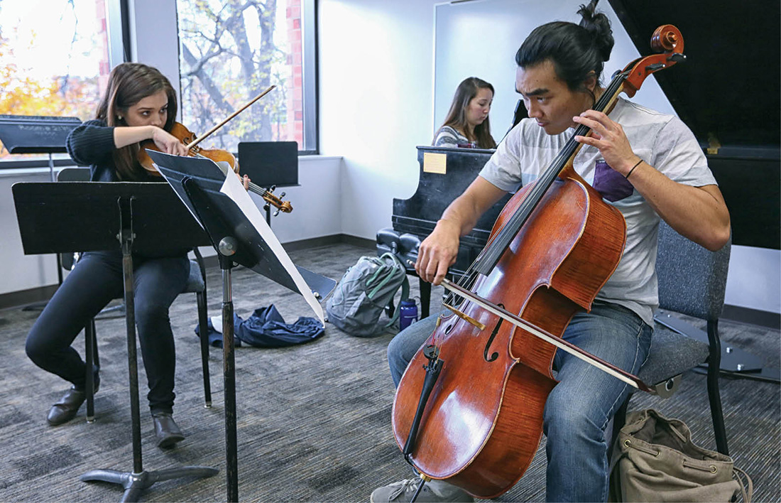 Sabrina Bradford (violin), Antonia Rohlfing (piano) and Blake Kitayama (cello) rehearse their chamber music piece at the Blair School. Photo by Anne Rayner