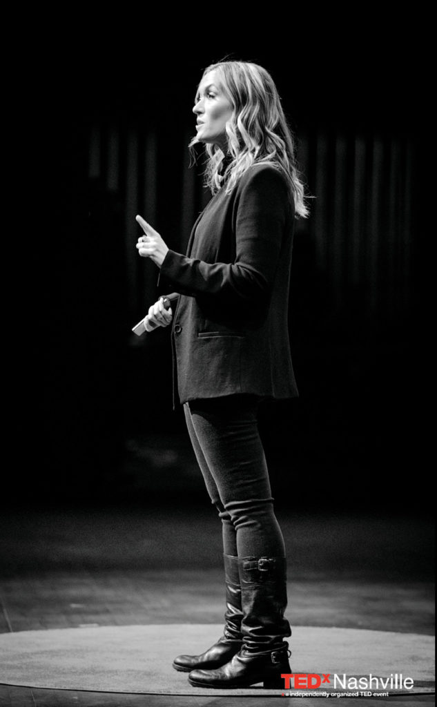 black-and-white photo of Kelly Goldsmith on the TEDx Nashville stage