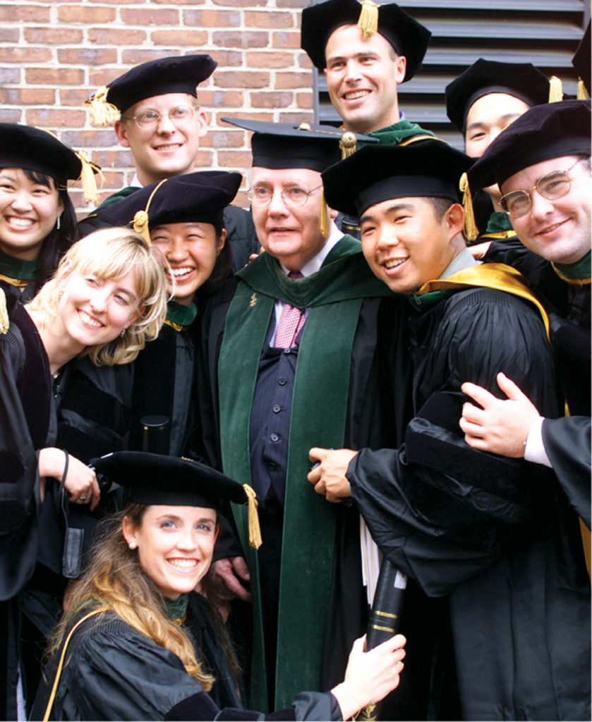 The VUSM Class of 2000 gives Dean John Chapman, center, a group hug after the school’s Commencement ceremonies. (DANA JOHNSON)