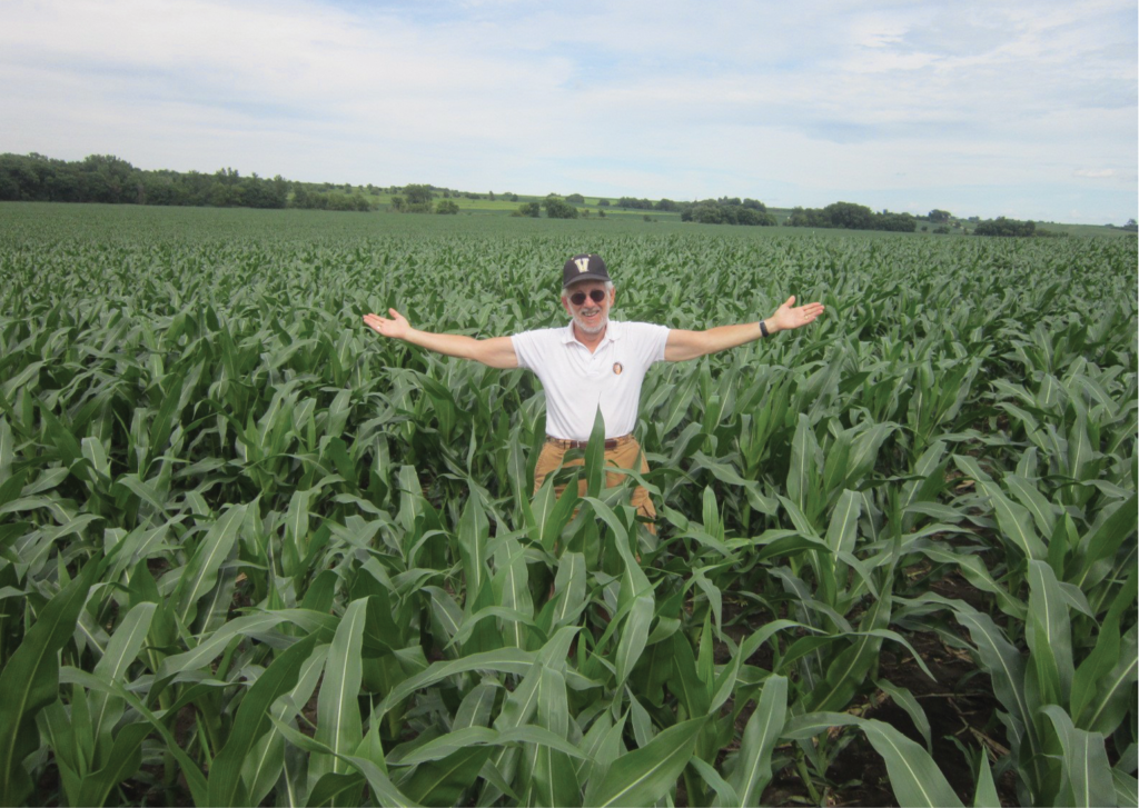 In this photo taken by Chuck Offenburger, BA’69, Paul Kurtz admires an Iowa cornfield on his way to watching the Commodores in the deciding game of the 2014 College World Series.