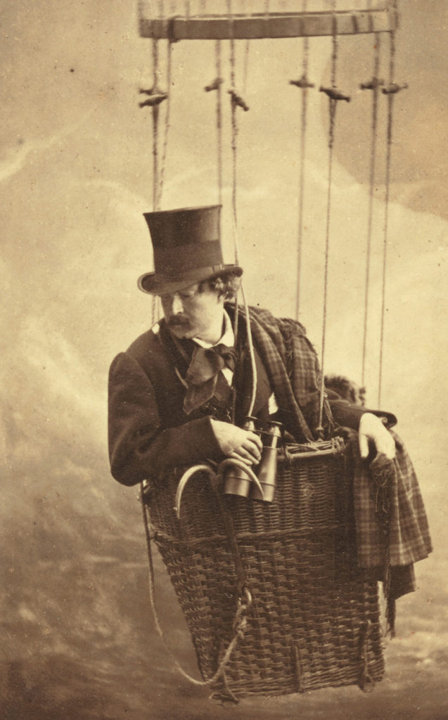 vintage photograph of man with binoculars in a hot air balloon
