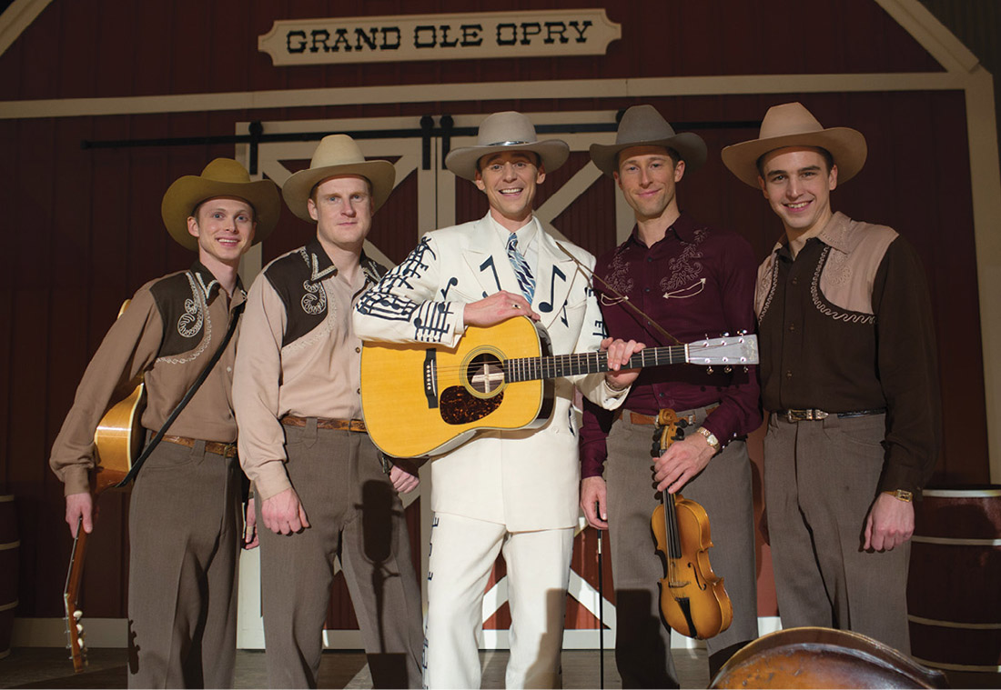 Michael Rinne (far right) as bassist Lum York, with actor Tom Hiddleston (center) as Hank Williams and members of the film version of Williams’ band, The Drifting Cowboys