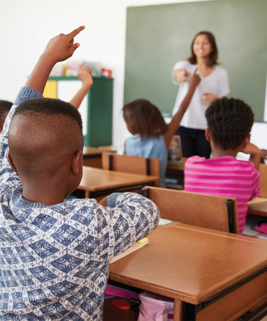 photo of a teacher leading a classroom of African American students