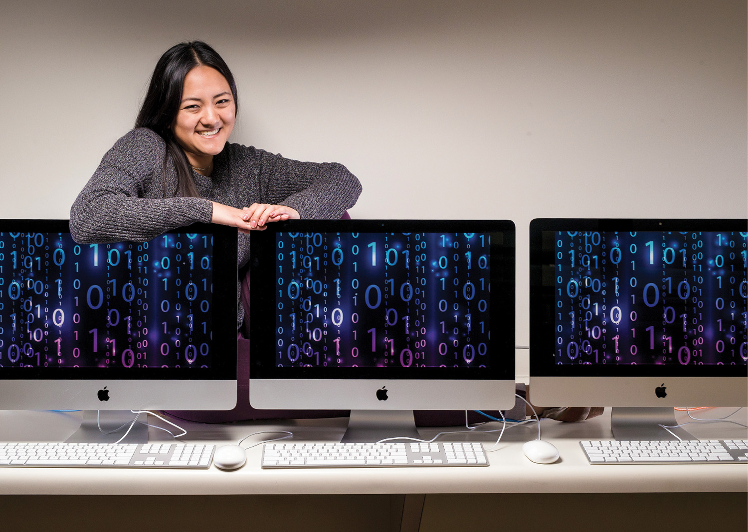 photo of Sami Chiang sitting behind three iMac screens