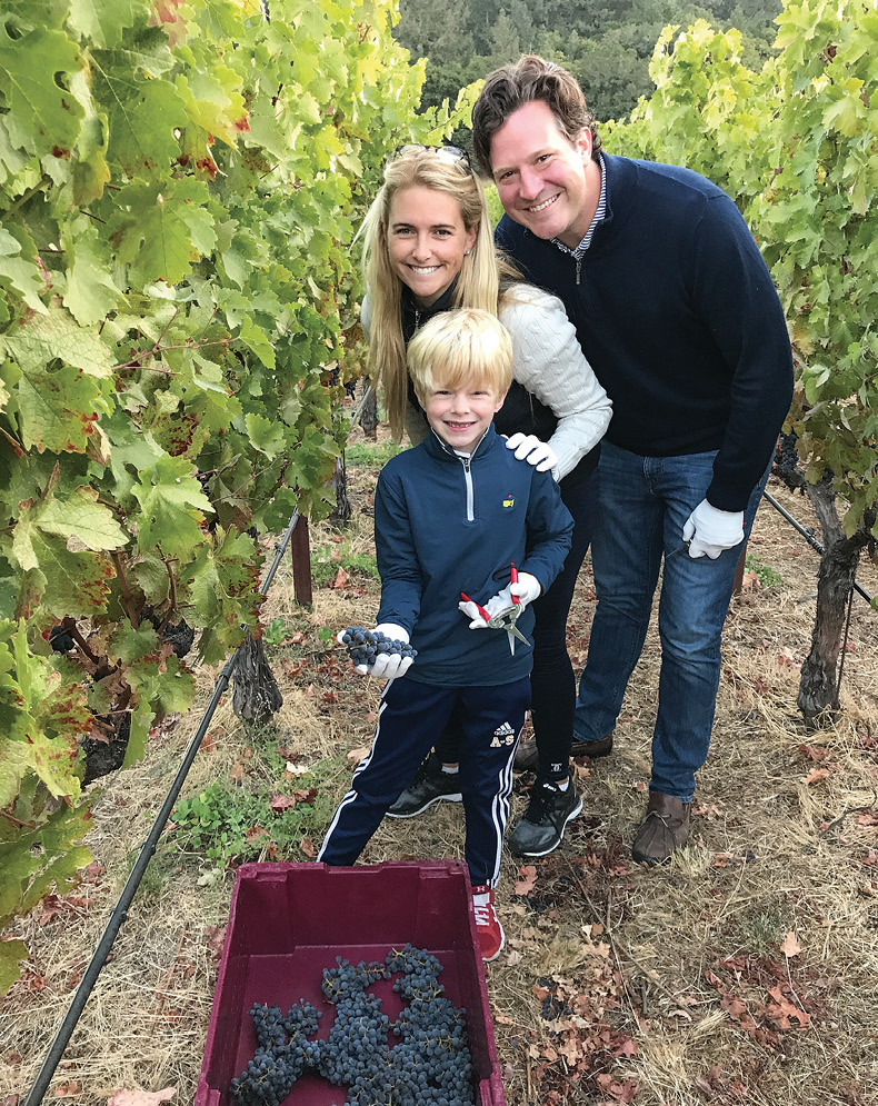 photo of McCartney and Jay Wilkins with their son at a vineyard